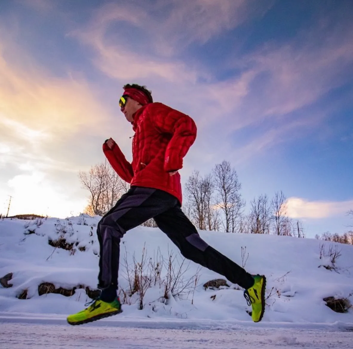 Smartpads team member running through fresh snow outdoors in a red jacket
