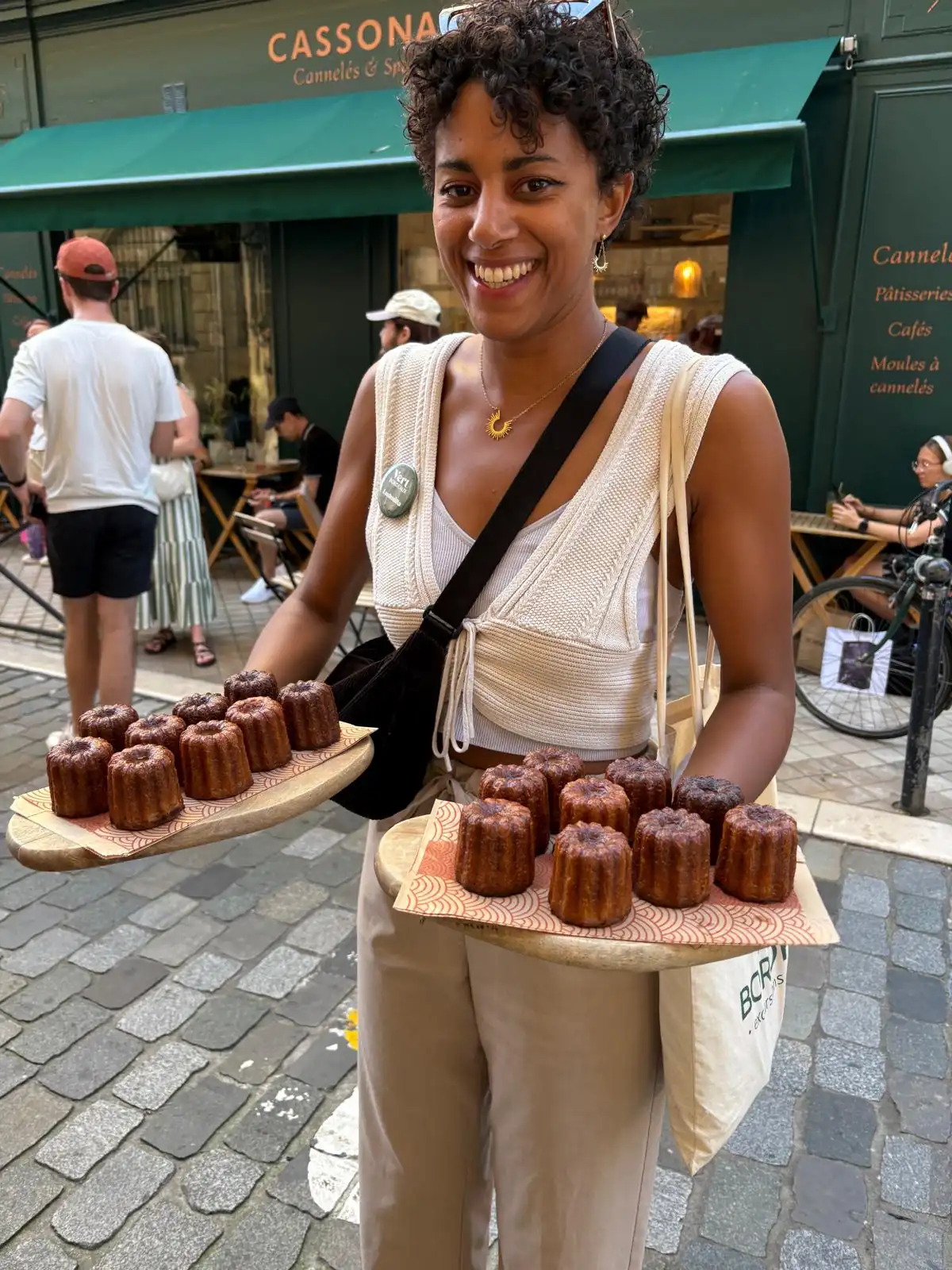 epicureans traveller holding pastries in city streets