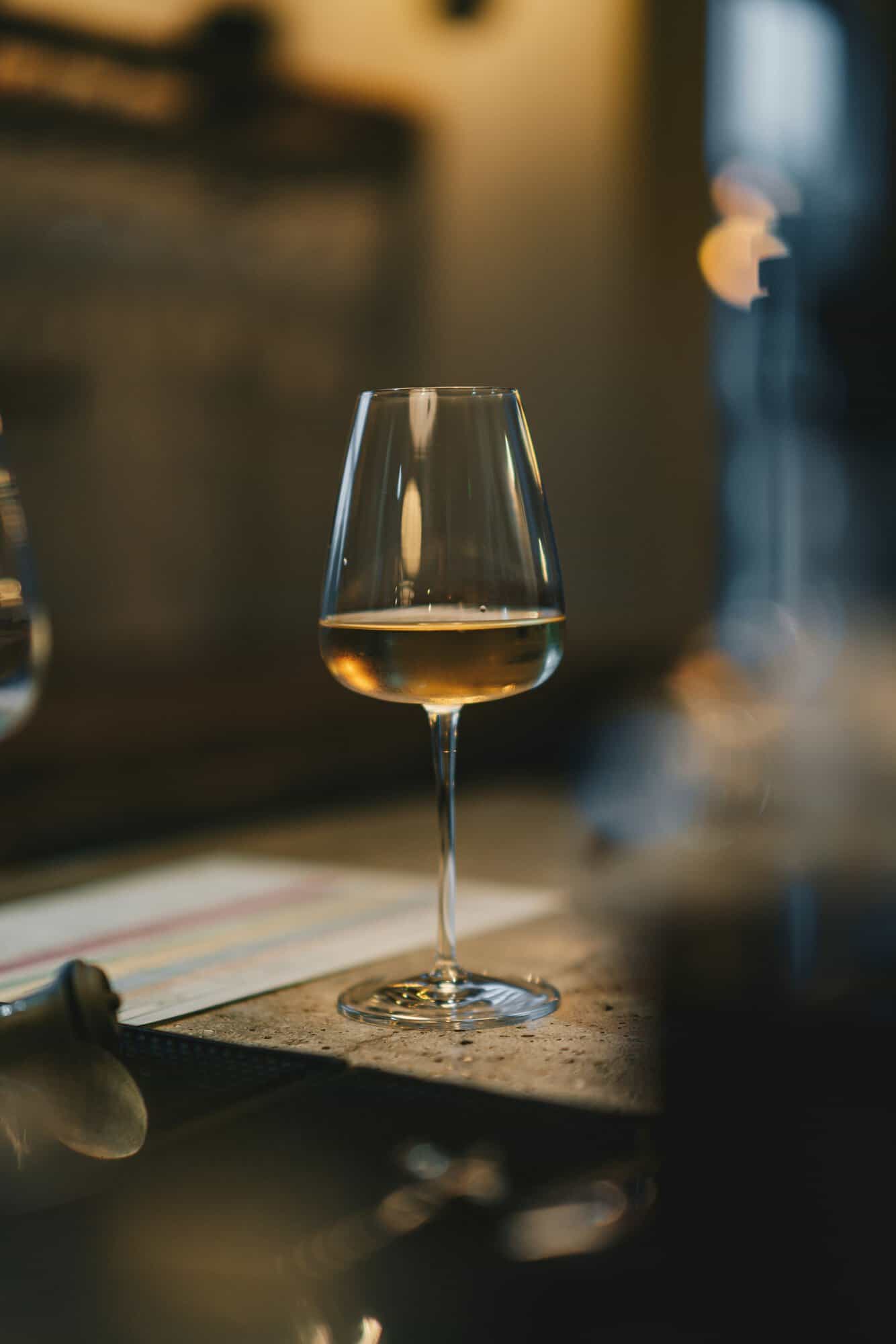 wine glass on dimly lit restaurant table
