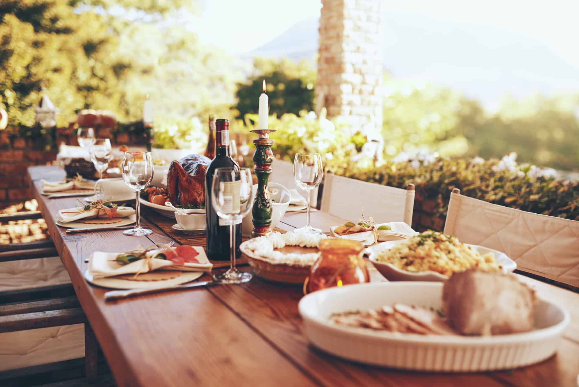full dinner table with food and drinks outside