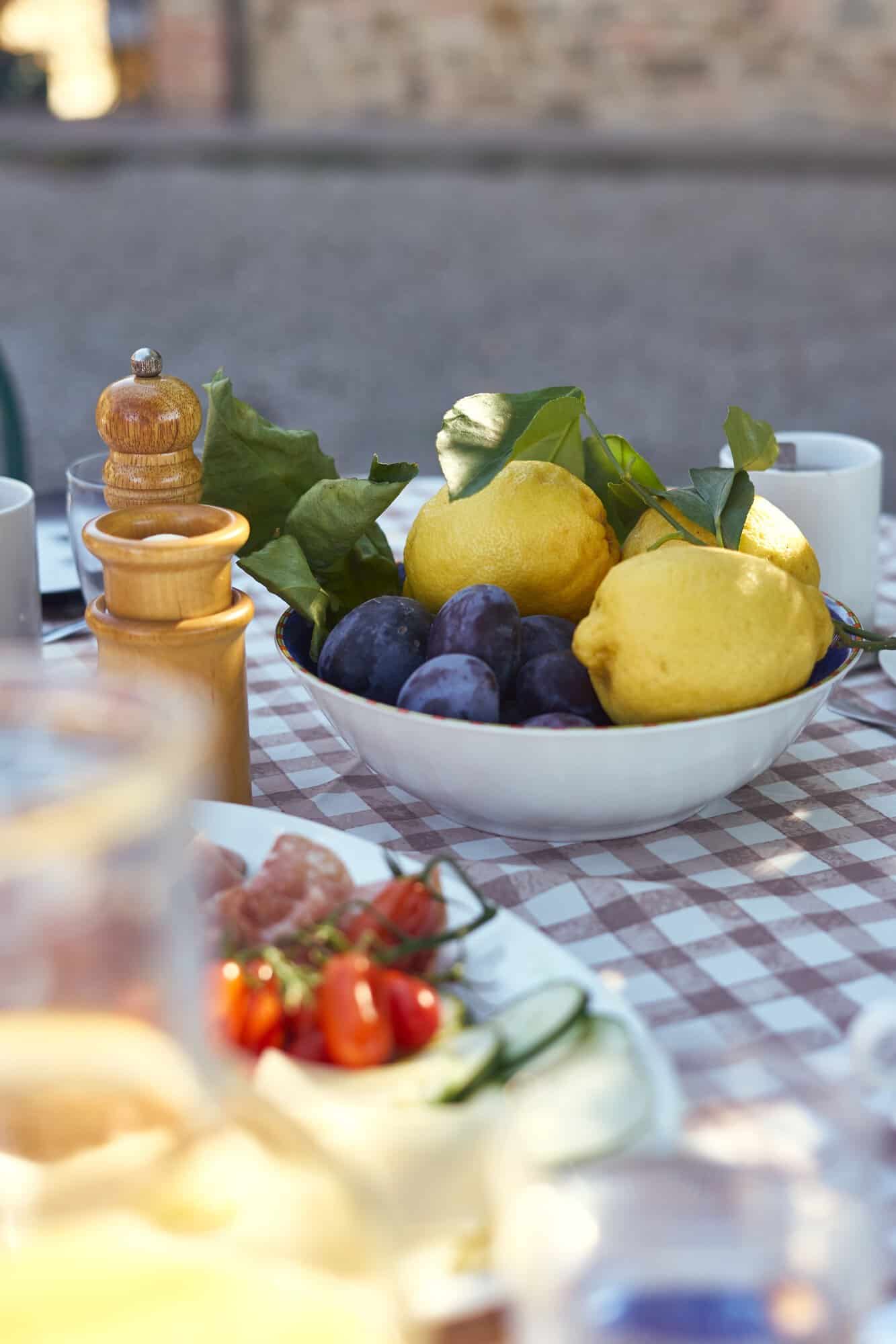 bowl of fruit set on picnic table