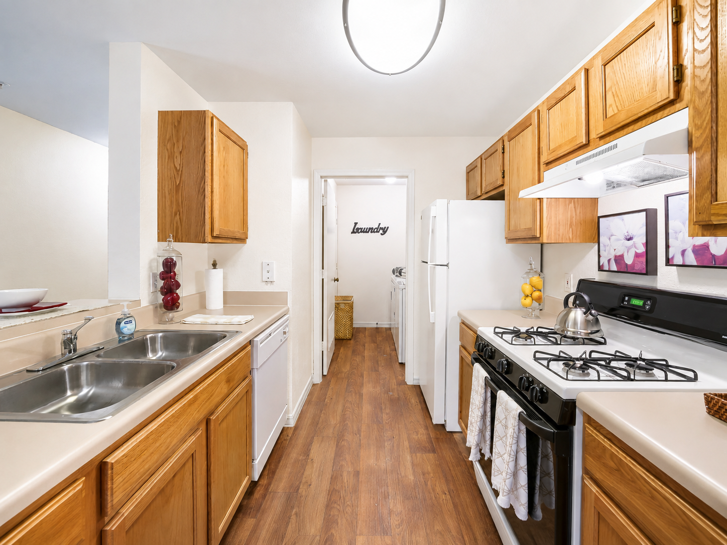 Kitchen with wood cabinets and white appliances 