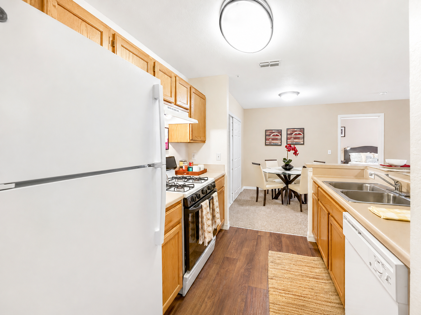 Kitchen with wood cabinets and white appliances 
