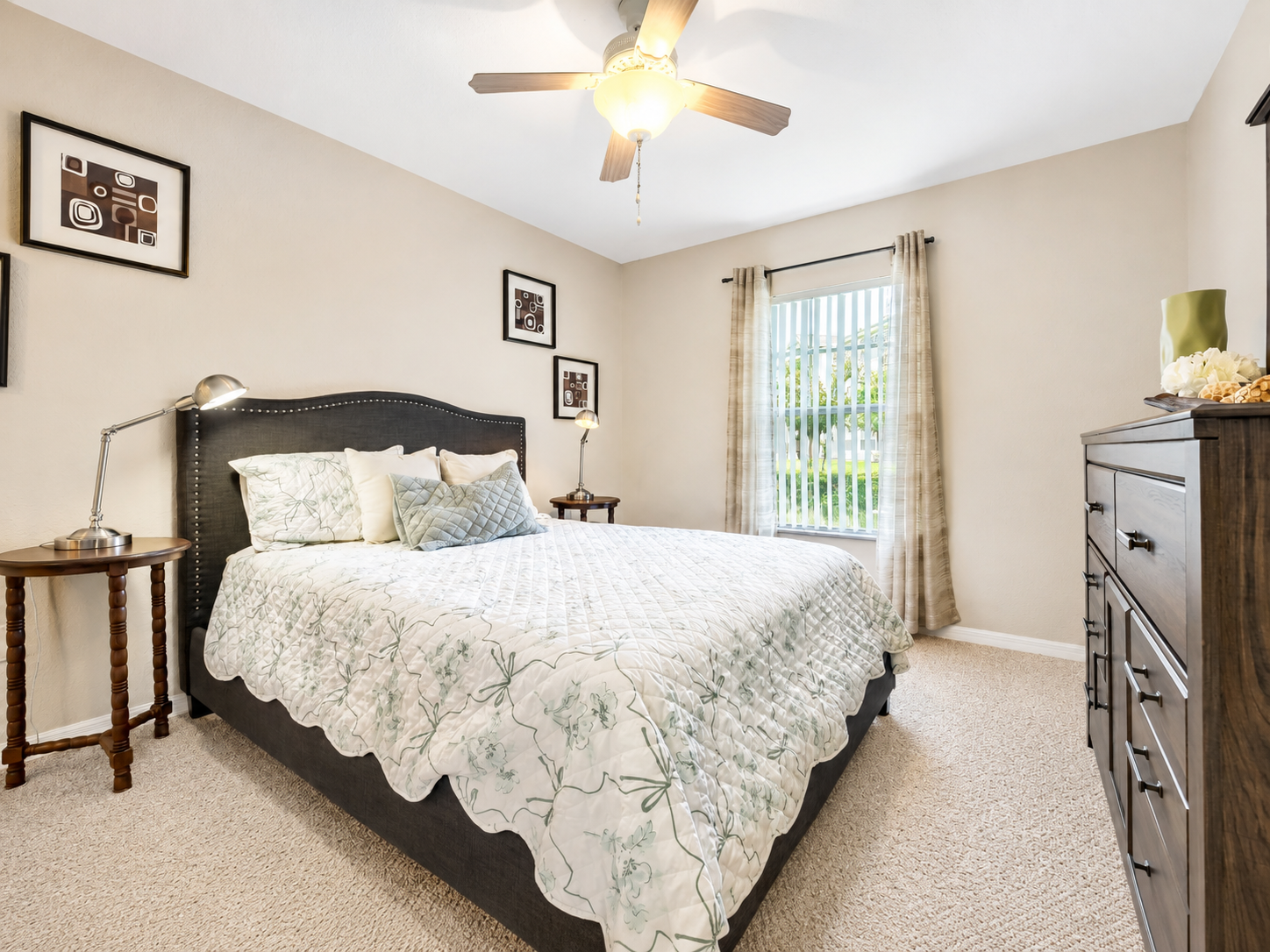 Bedroom with bed, ceiling fan, and large window