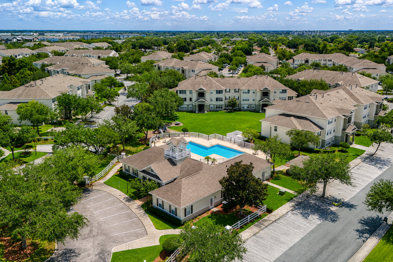 Aerial view of exterior and surrounding area with view of swimming pool