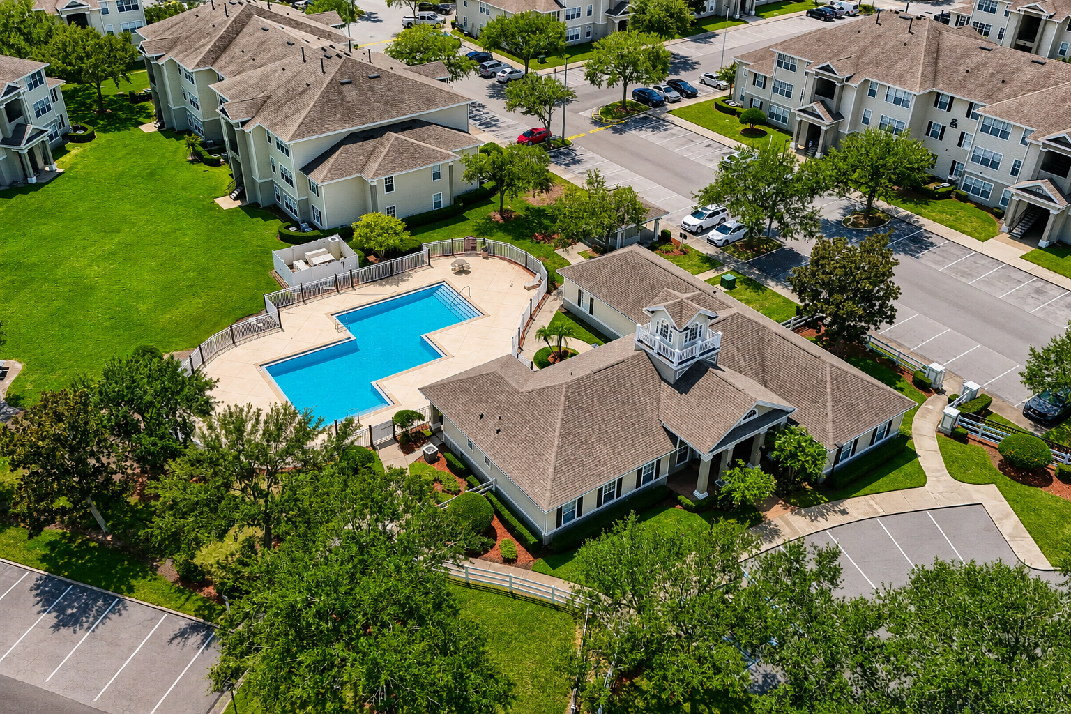 Aerial view of exterior and surrounding area with view of swimming pool