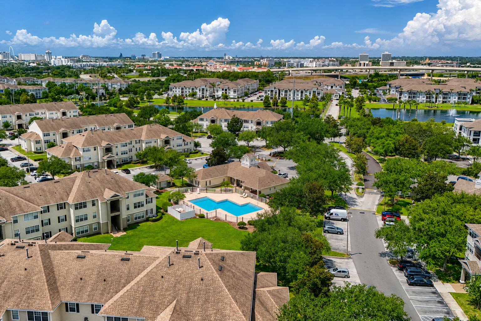 Aerial view of exterior and surrounding area with view of swimming pool