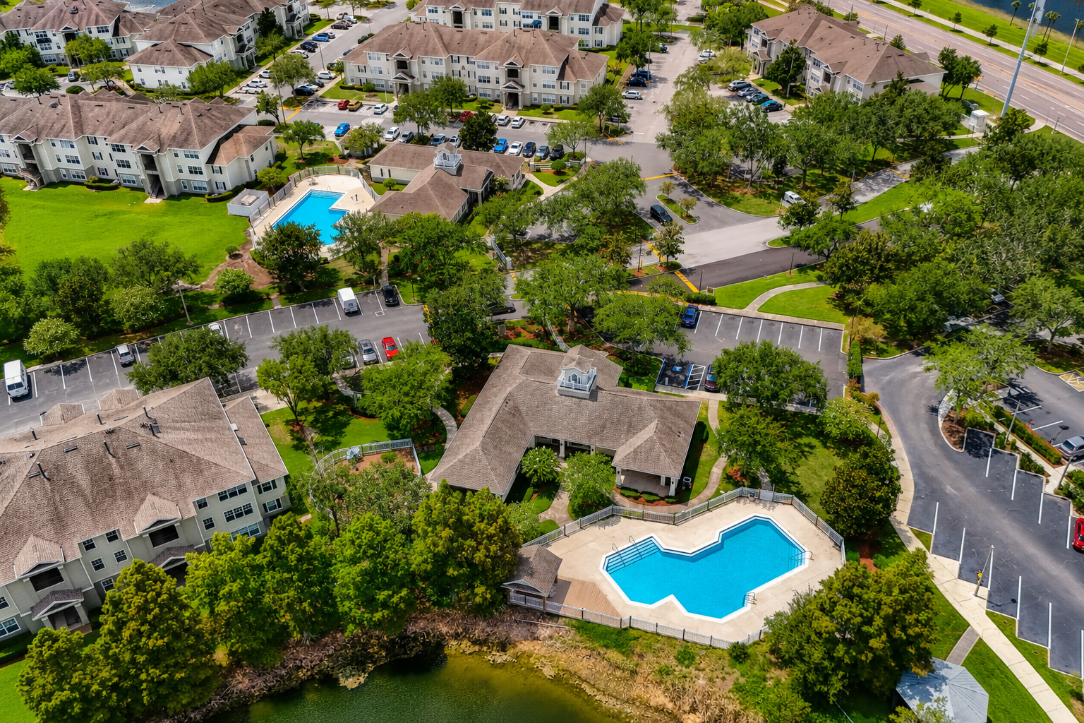 Aerial view of exterior and surrounding area with view of swimming pool