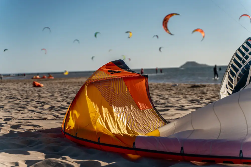 Kites and twin-tip boards laid out on the beach ready for a session in Dakhla