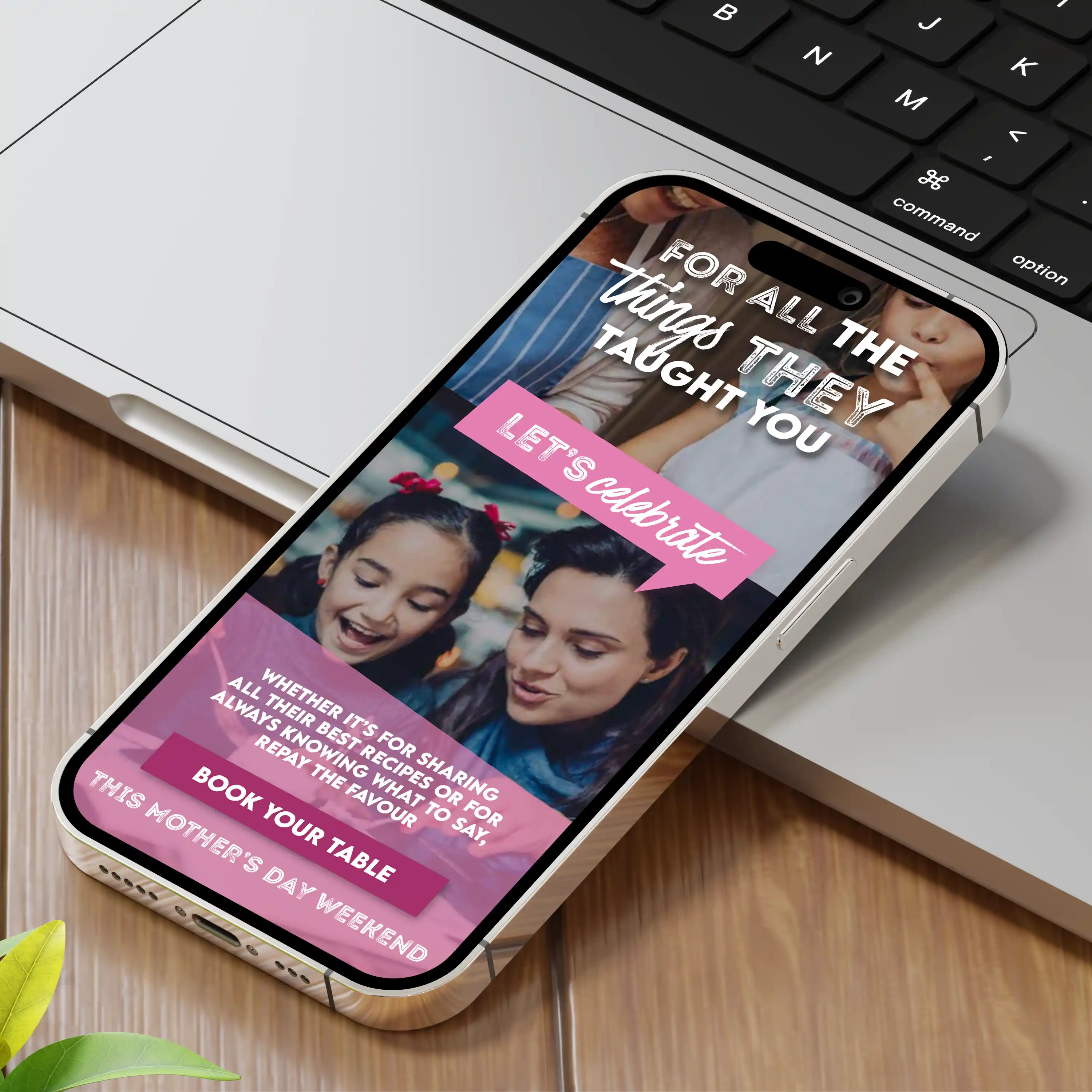 Smartphone on table showing Mother's Day booking ad with woman and child smiling together.
