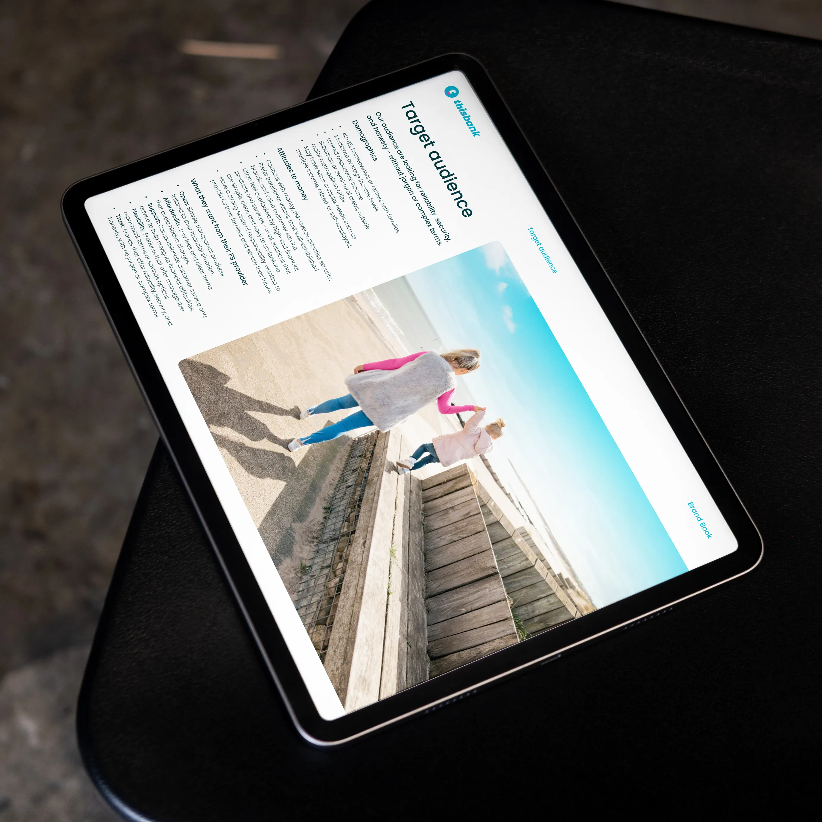 Tablet displaying a document titled 'Target audience' with a photo of a woman and child walking on a beach.