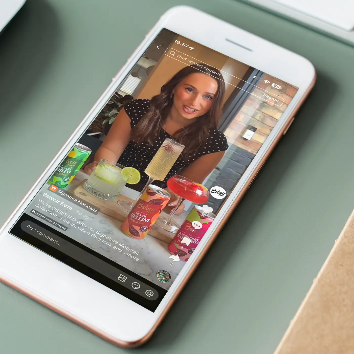 Smartphone screen showing a woman in a video promoting Belvoir Farm signature mocktail drinks.