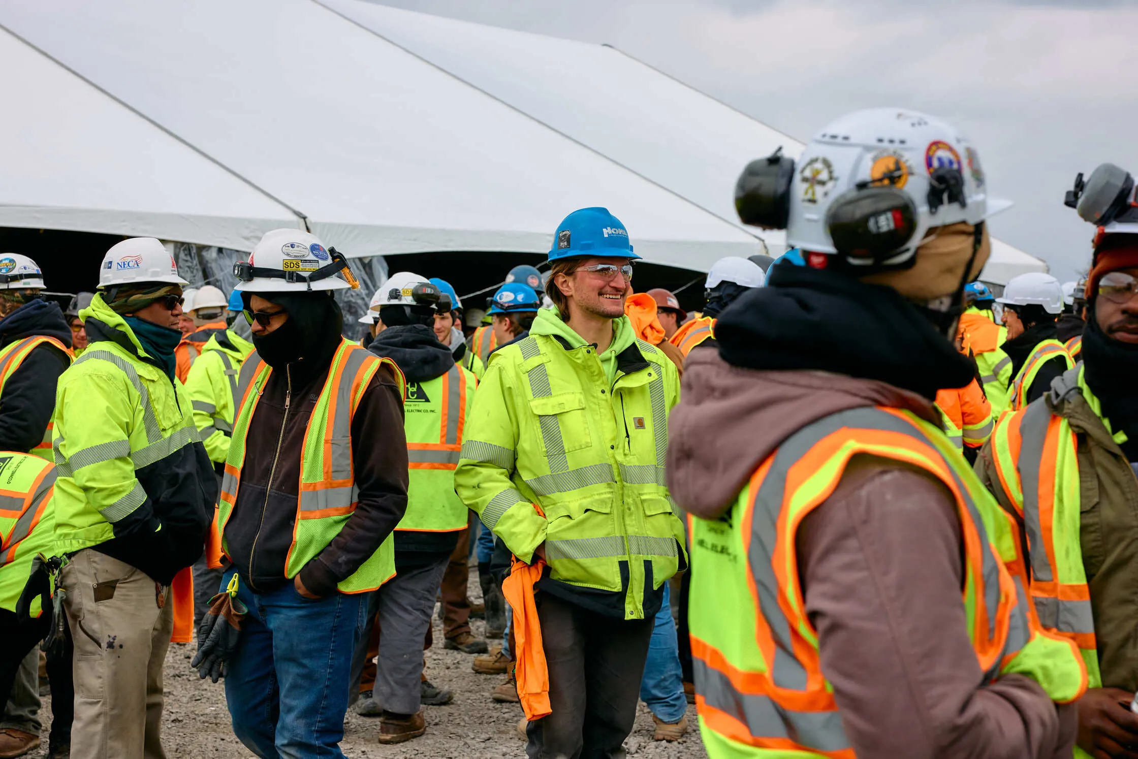 Local construction workers in hard hats gathered at a TeraWulf Lake Mariner site event.