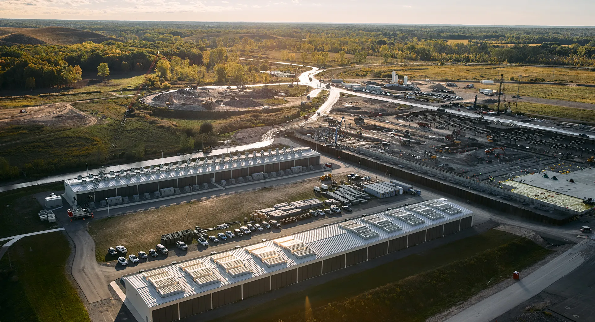Aerial view of TeraWulf Lake Mariner data center campus at sunset with cooling units and switchyard.