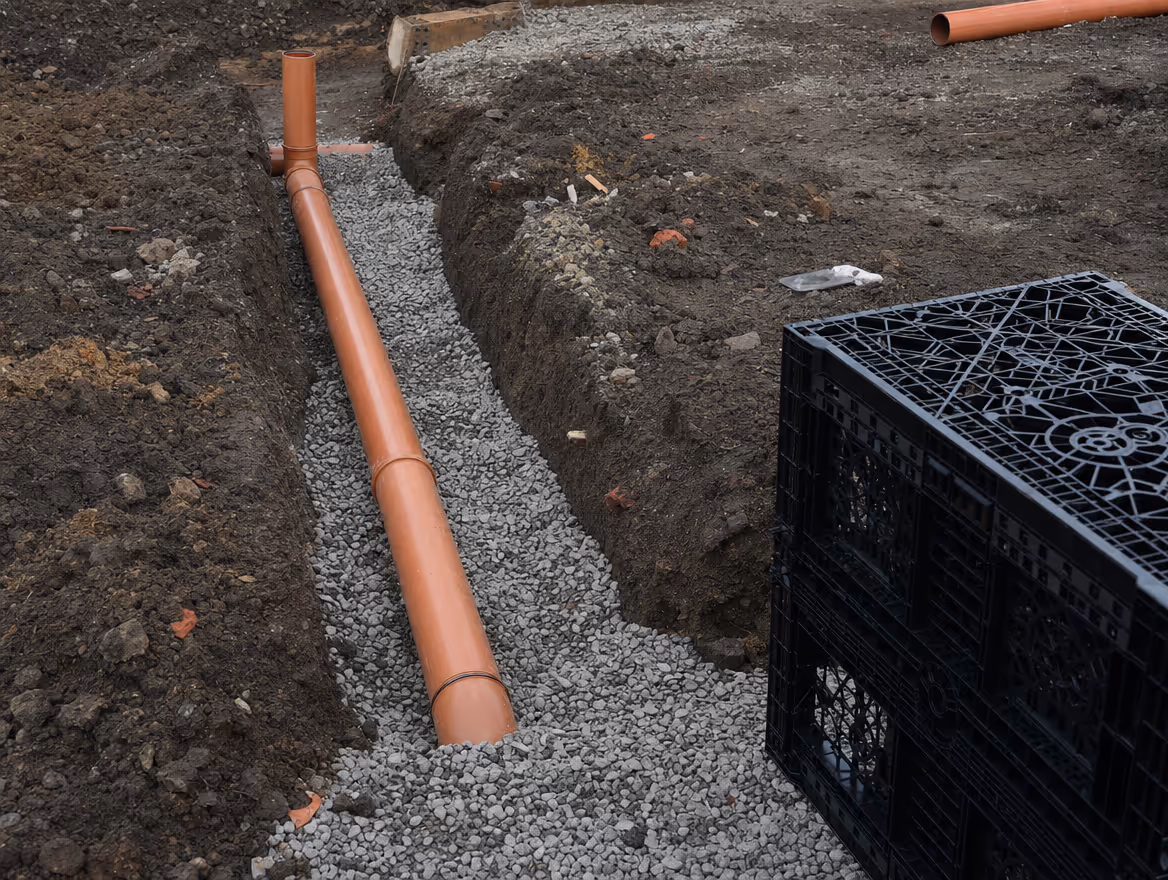 New drainage pipes being installed in an open trench