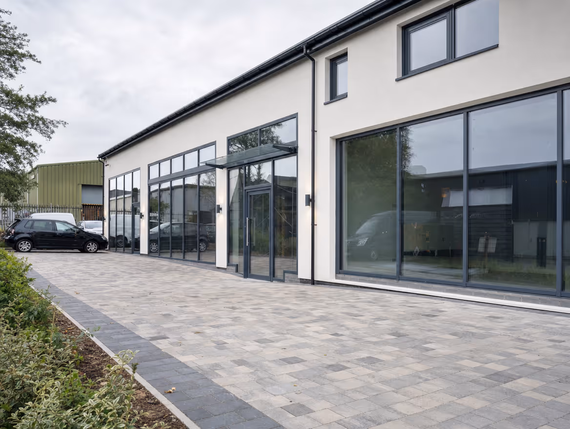 Completed commercial unit with new glazing and clean rendered facade