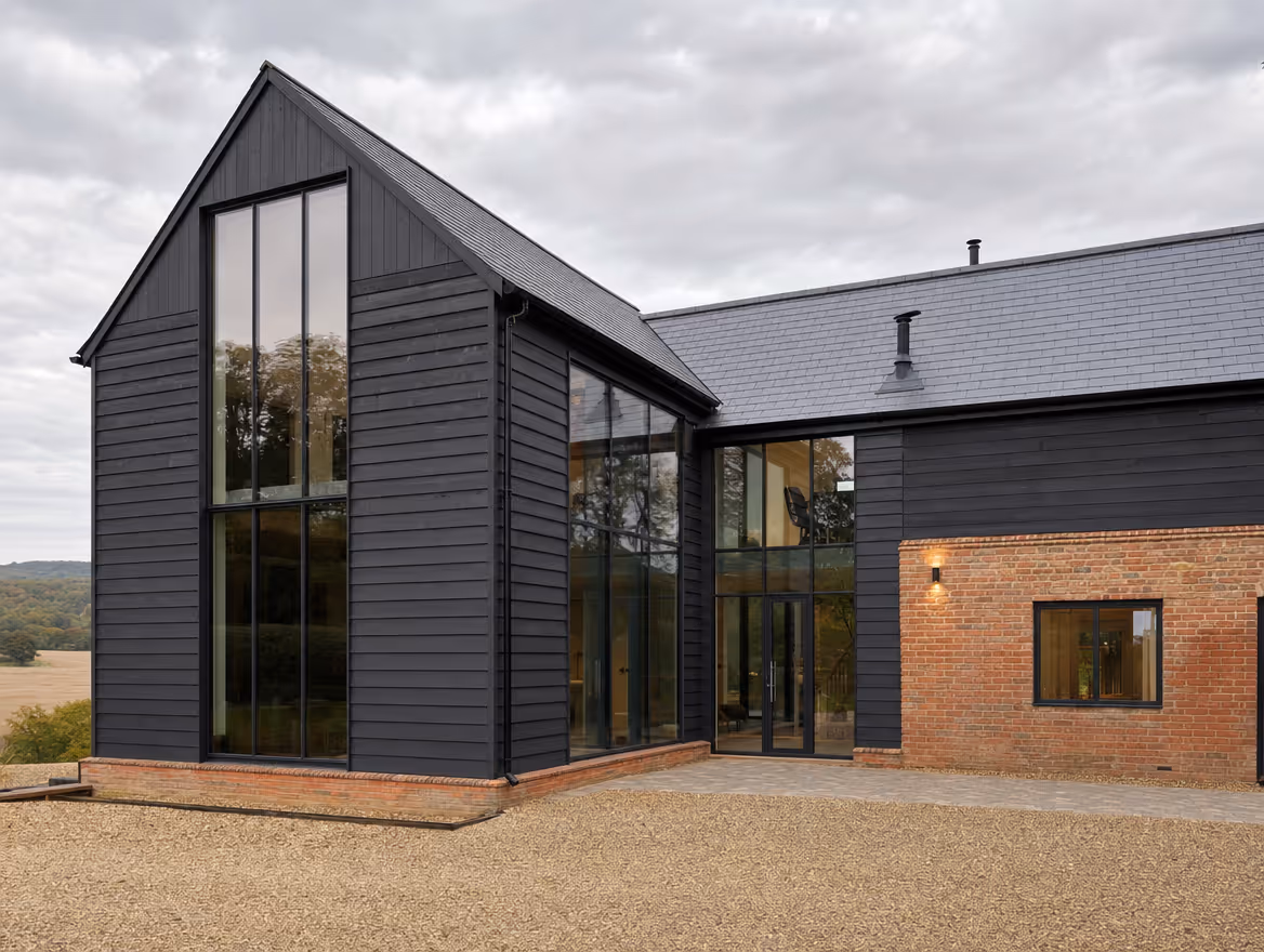 Converted barn exterior with black timber cladding and glazing