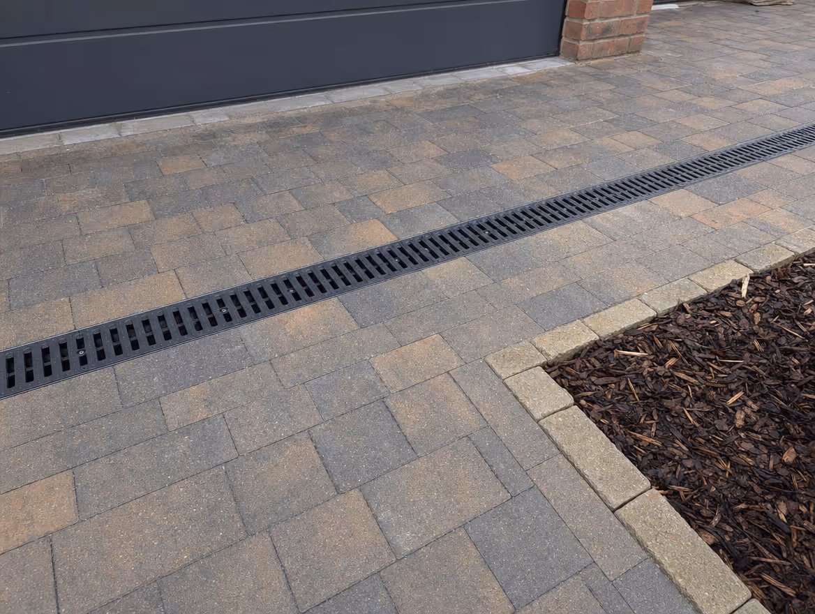 Completed surface water drainage with a linear channel drain set into paving