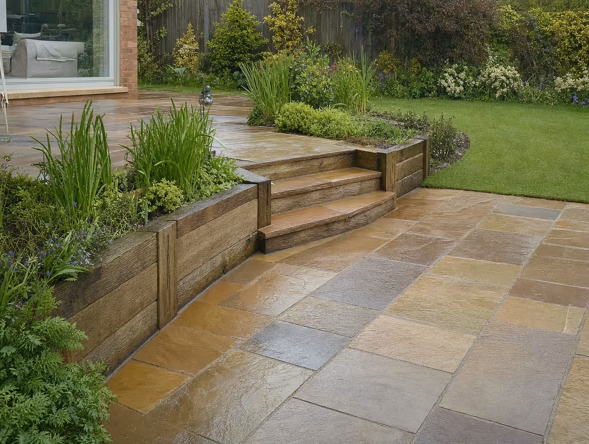 Natural sandstone patio with steps and sleeper retaining wall