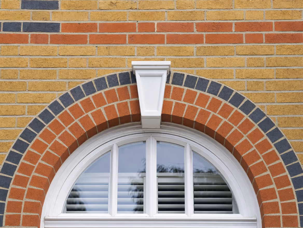 Decorative brickwork with an arched brick lintel and crisp pointing