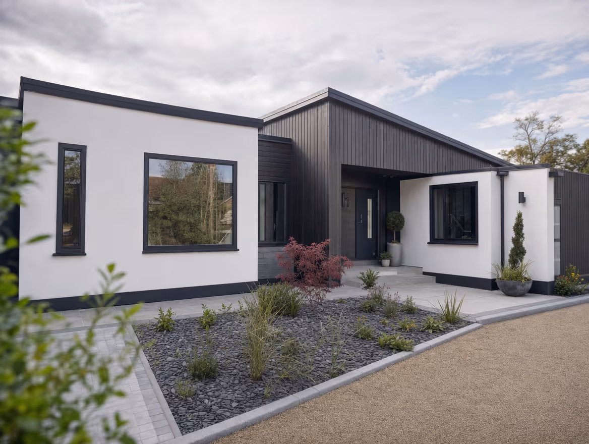 Modern new build bungalow with white render and dark timber cladding