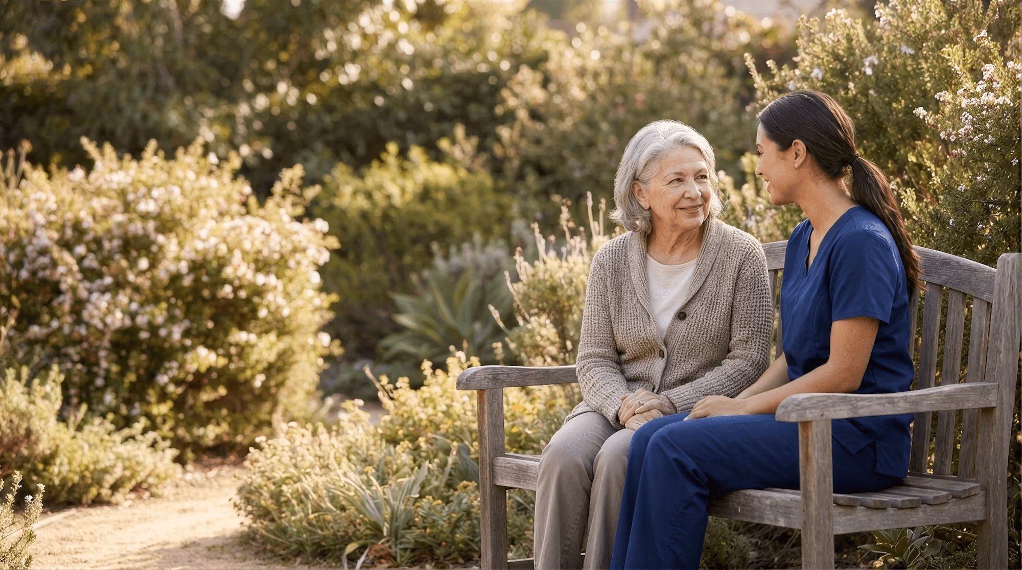 Care provider speaking to elderly woman.