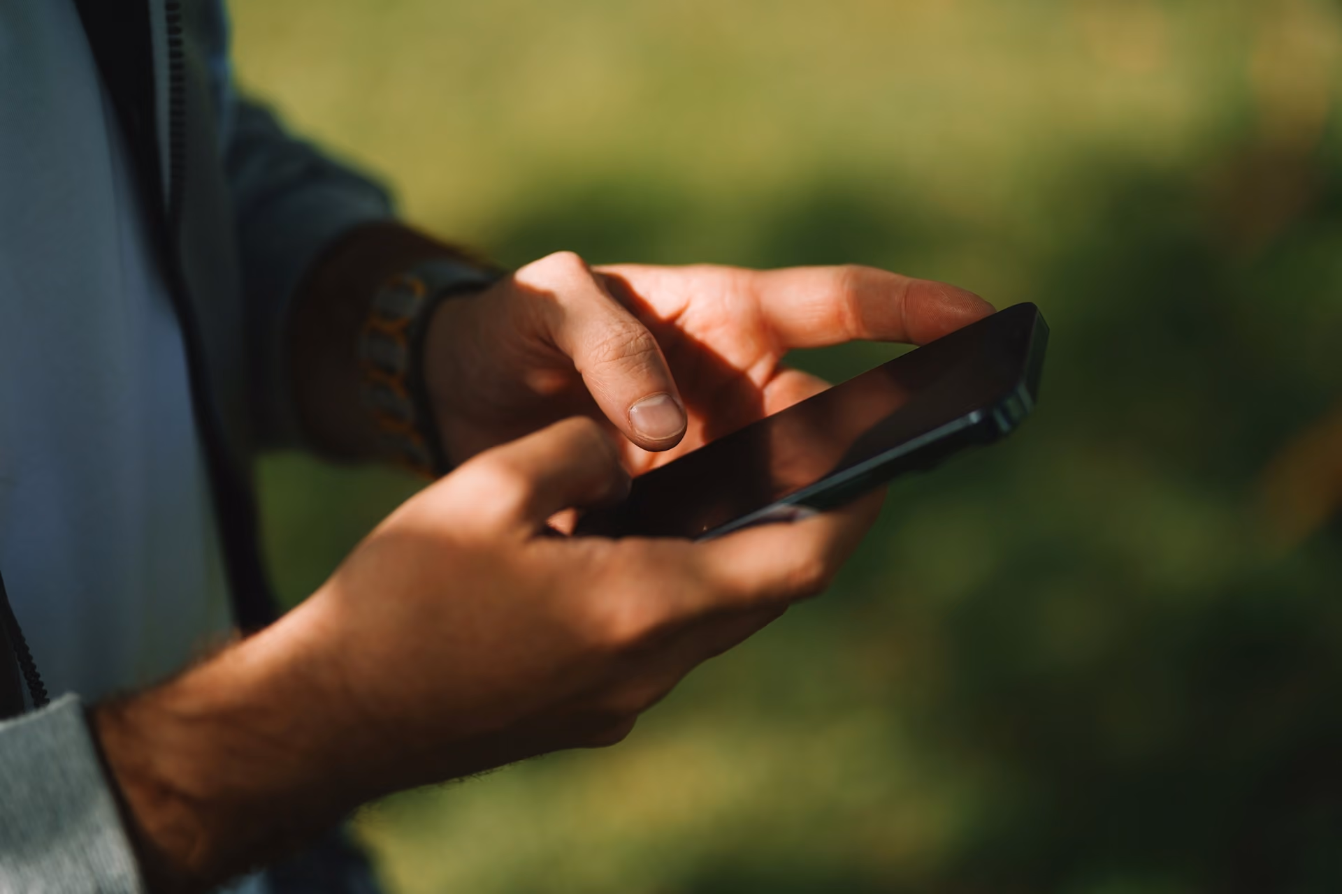 Man's hands holding phone.