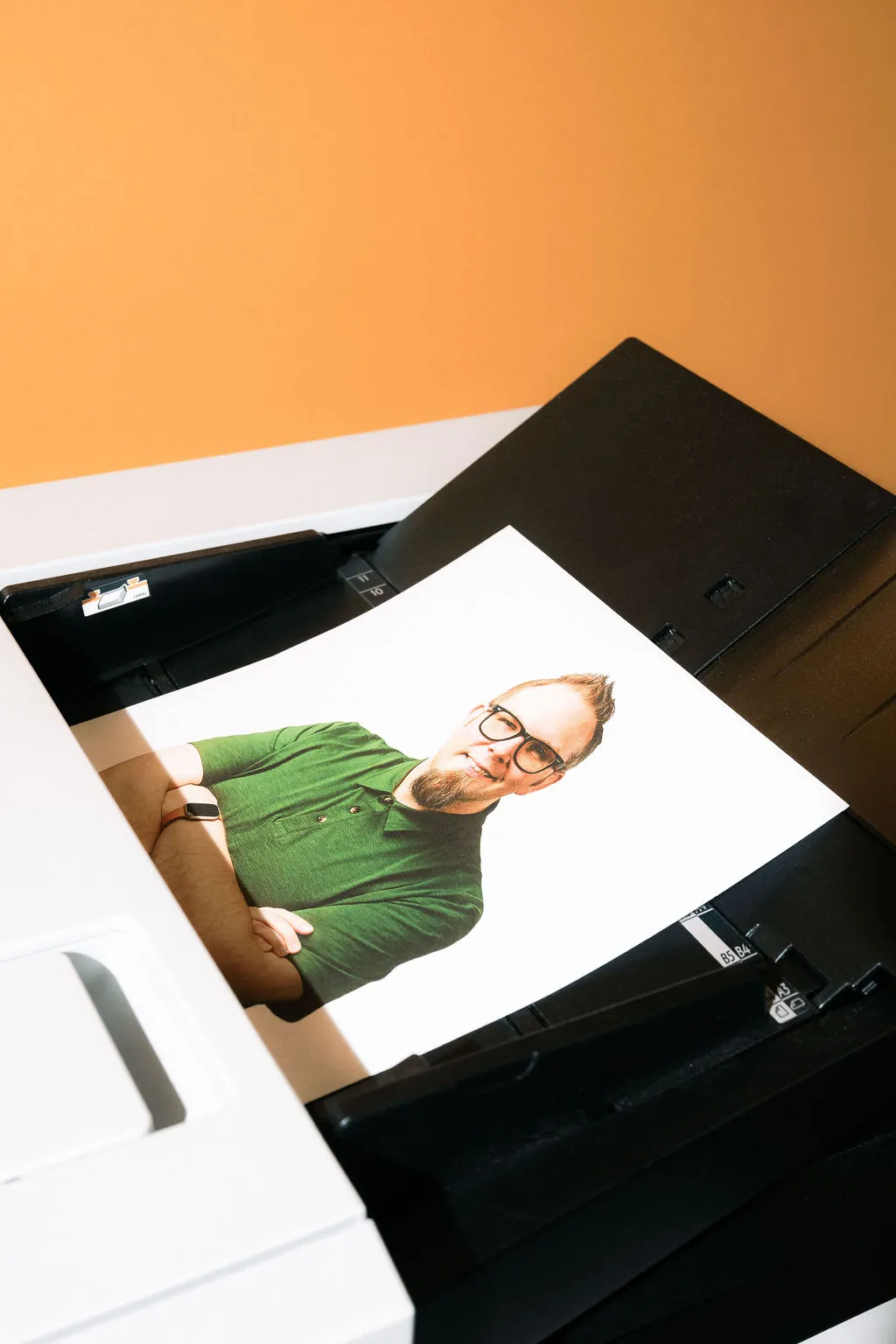 A man lying across an open photocopier being scanned