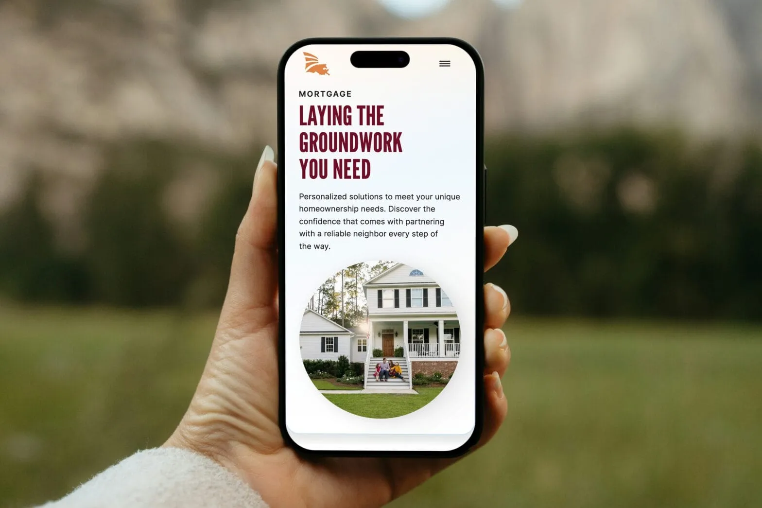 A hand holding a phone showing a bank page headlined Laying the Groundwork You Need