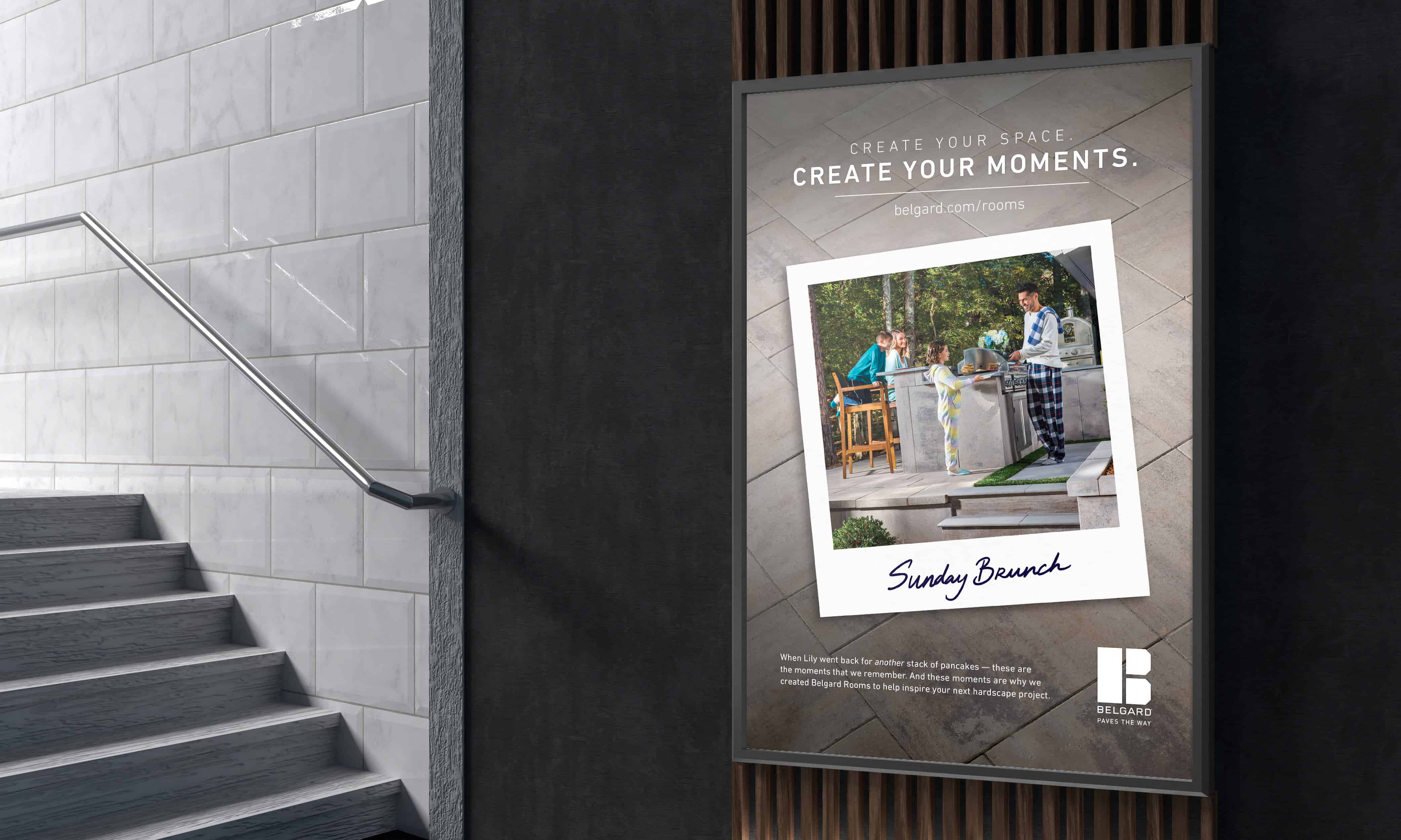 A Belgard Create Your Moments poster displayed in a tiled stairwell