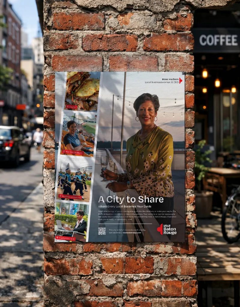 A Visit Baton Rouge A City to Share poster on a brick wall beside a coffee shop
