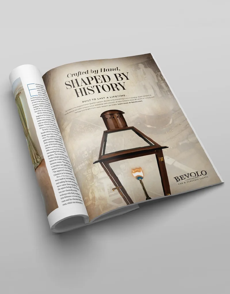 A rolled magazine showing a Bevolo ad headlined Shaped by History