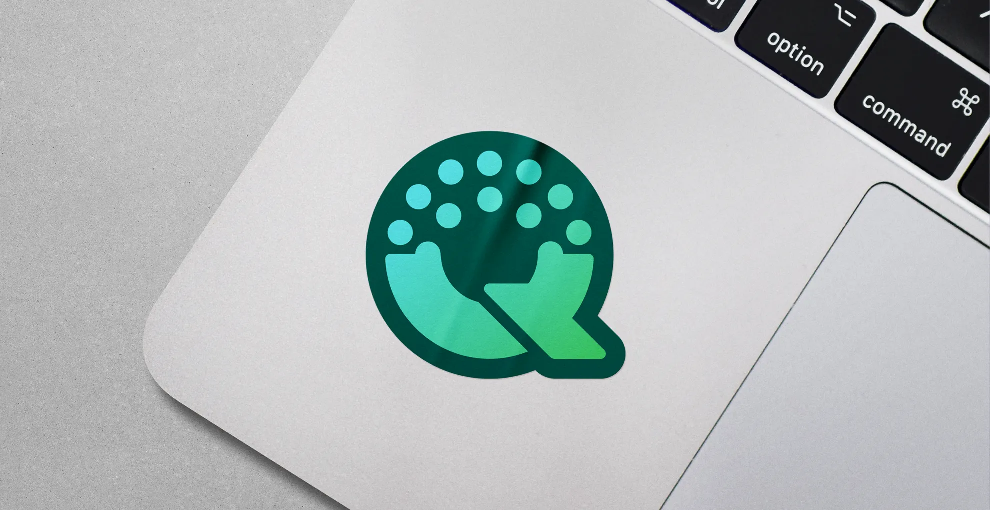 A Qtopia logo sticker on a laptop