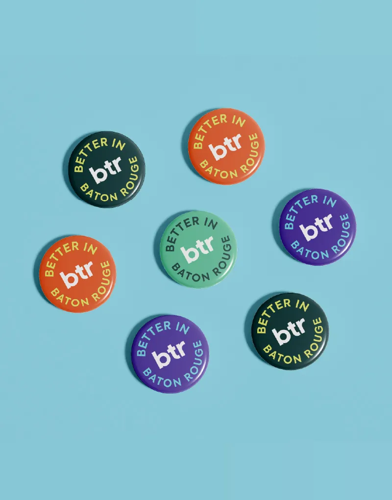 Better in BTR pin badges scattered on a pale blue background