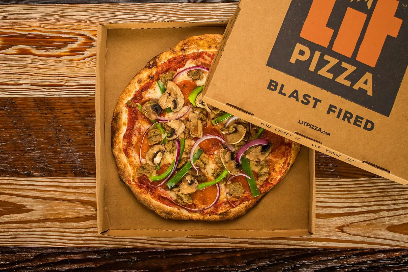 A blast-fired pizza in an open LIT Pizza box