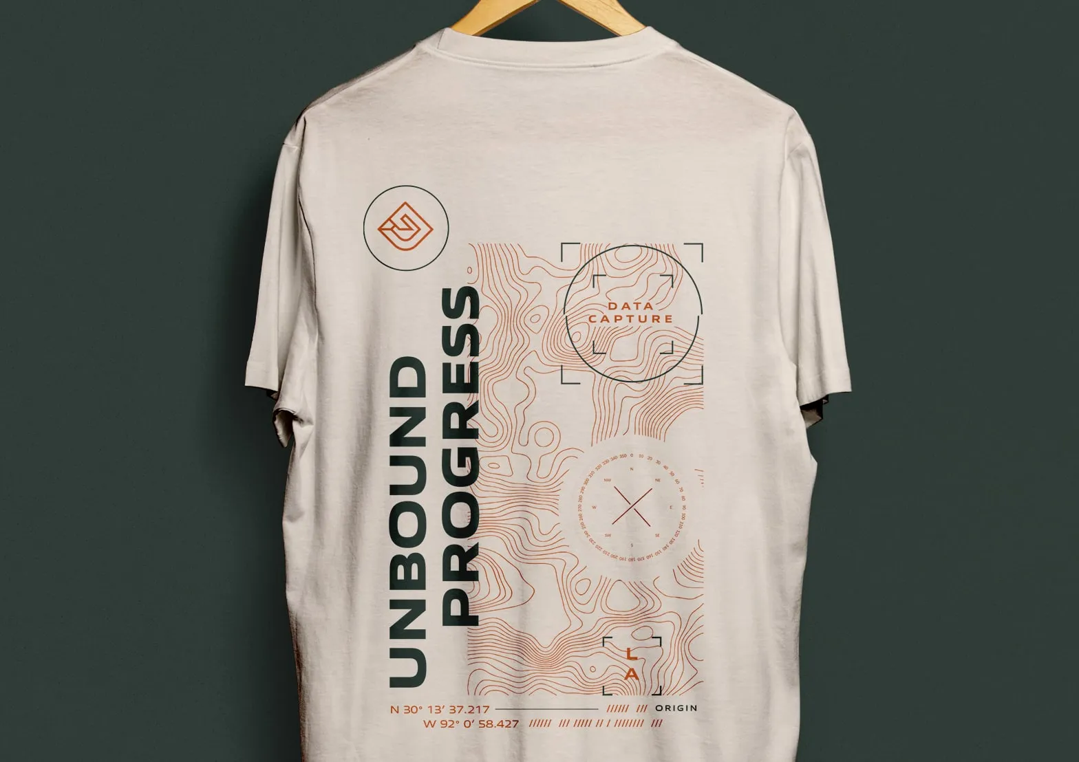 A FlyGuys t-shirt reading Unbound Progress hanging on a hanger