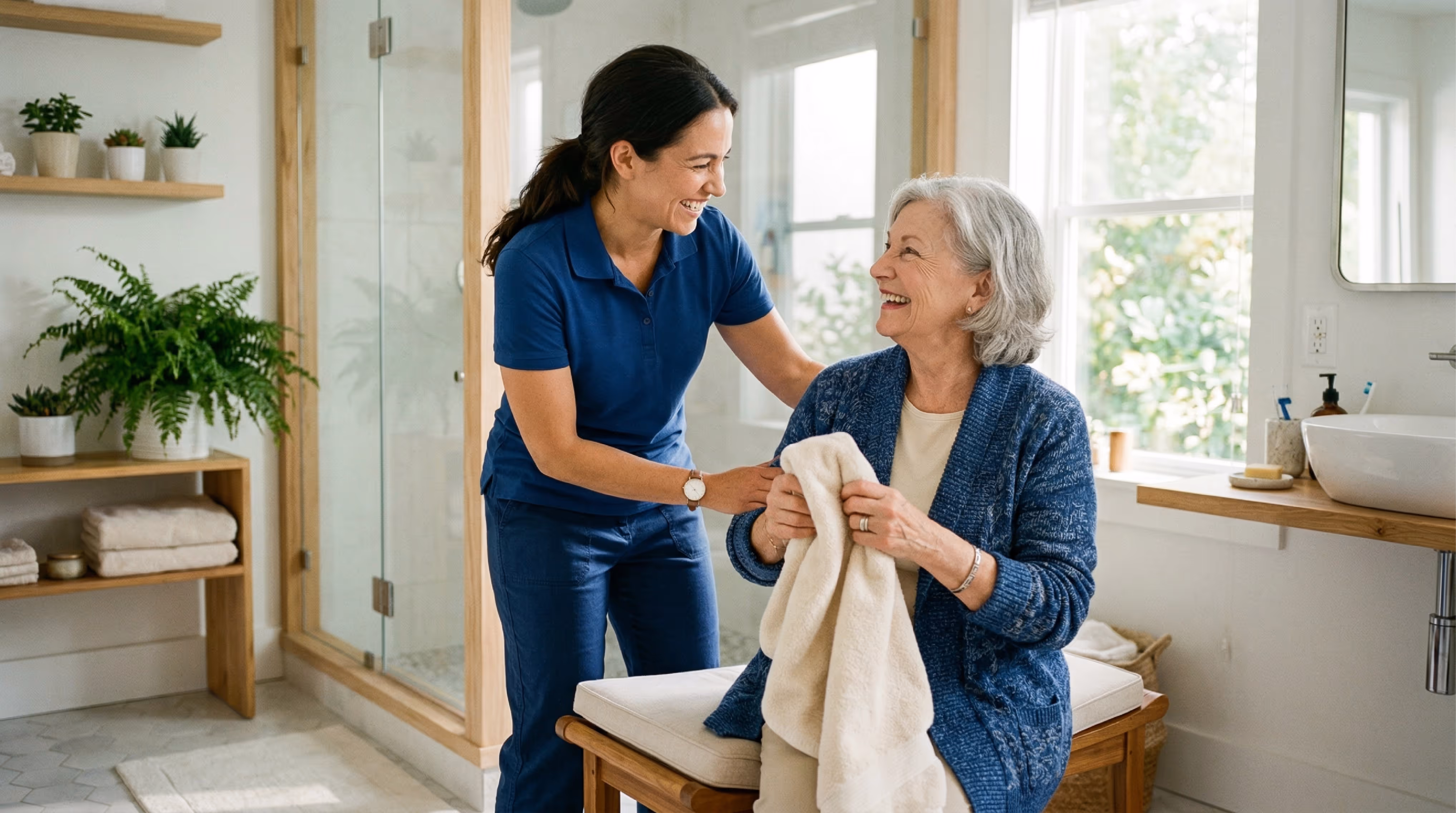 A female caregiver helping and elderly woman get ready for her bath. 