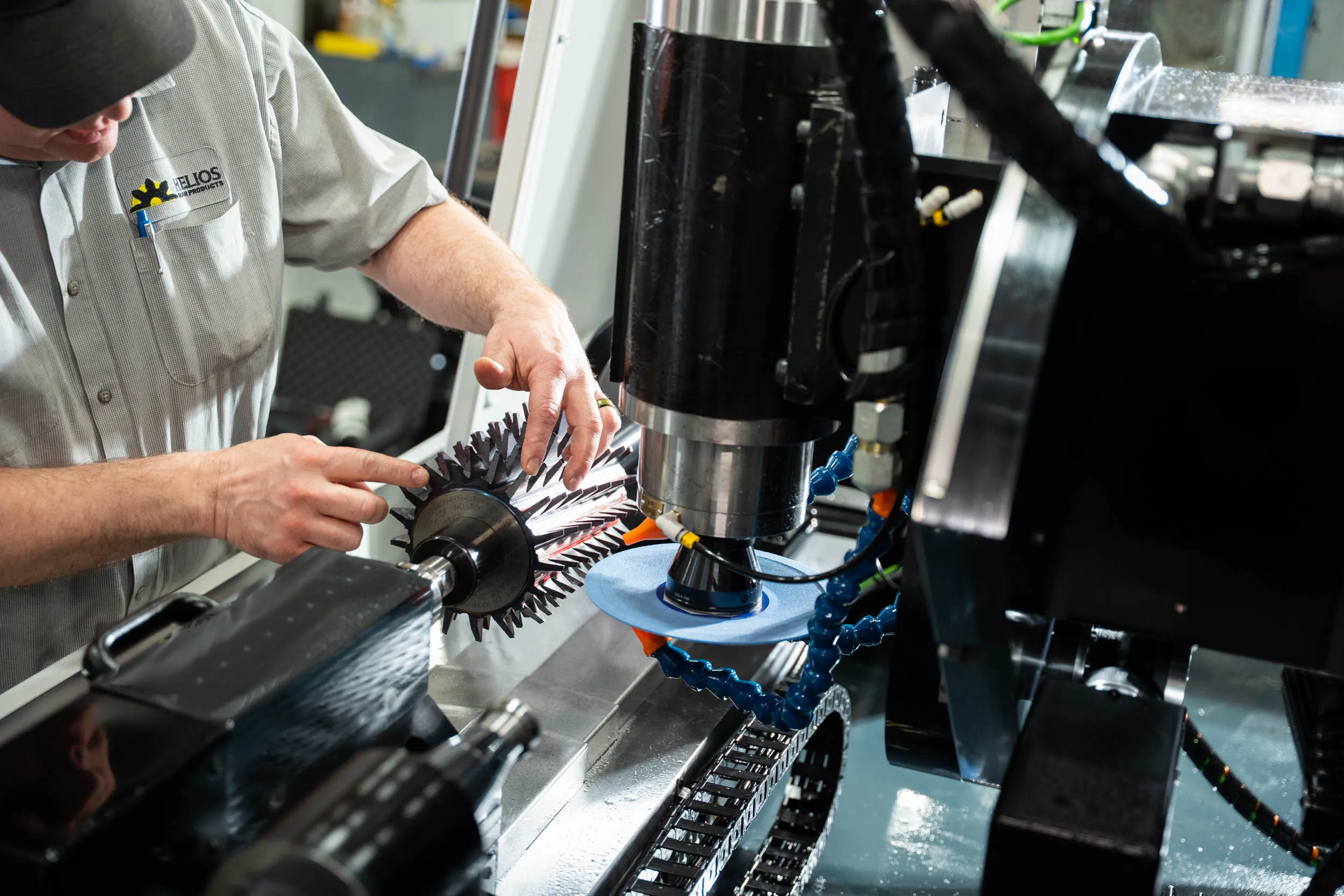 Helios technician loading a gear hob into a CNC sharpening machine