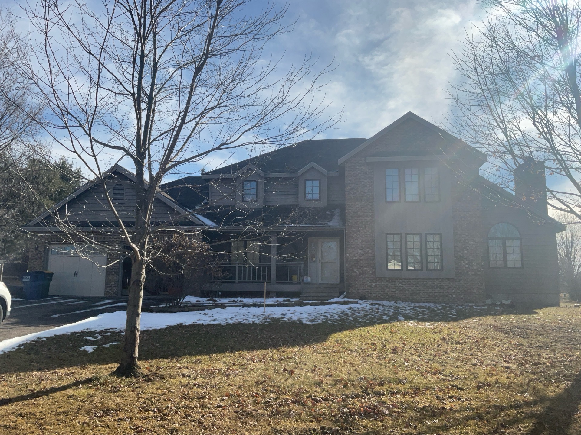 Before view of a two-story home in Schofield, WI before Norandex Olive siding installation.