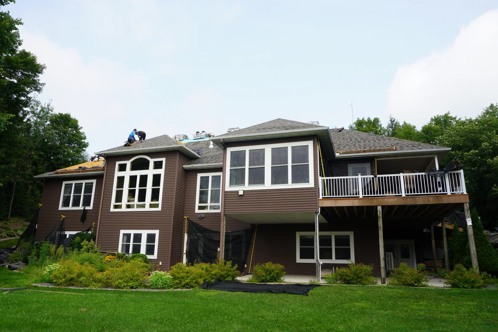 Professional roofing crew installing architectural shingles on a Wausau home Professional roofing crew installing architectural shingles on a Wausau home
