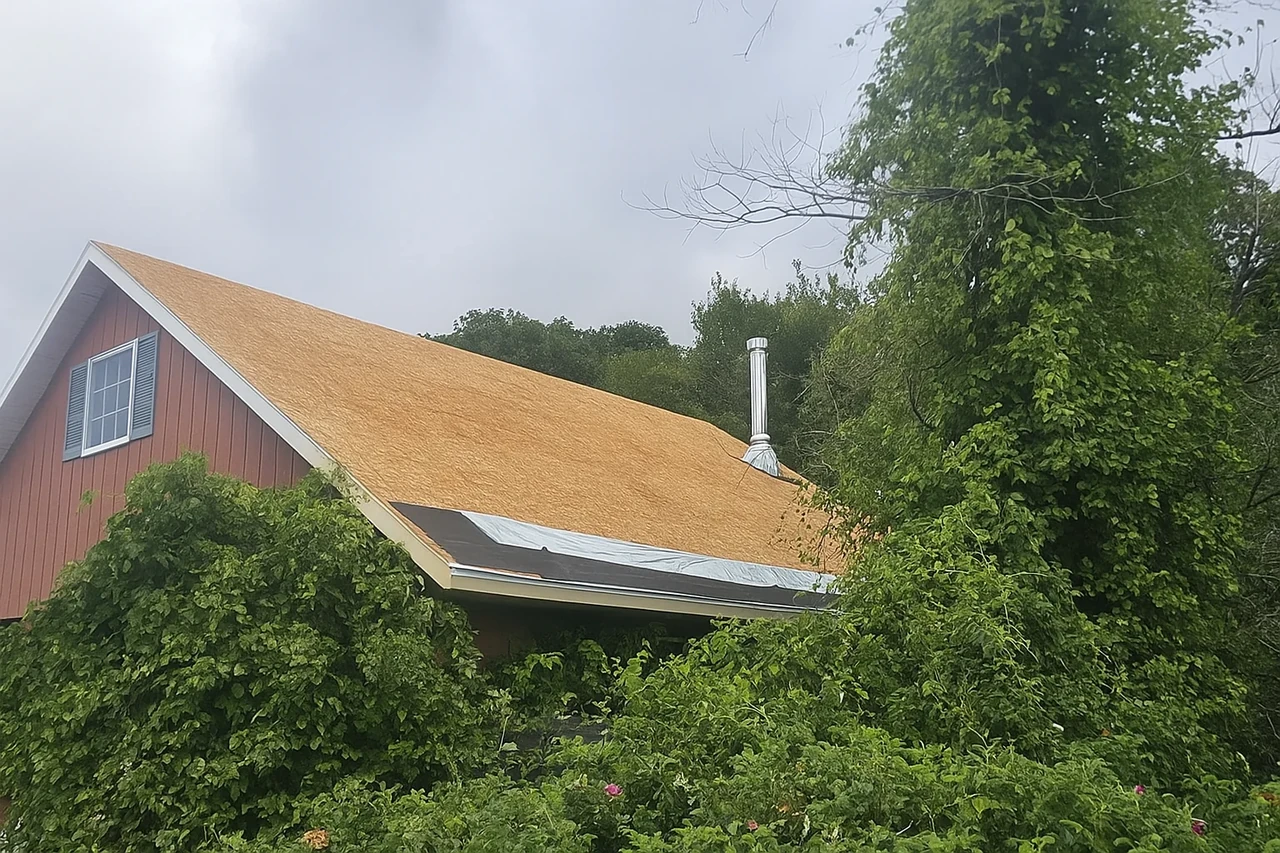 A professional roofing crew installing a high-quality ice and water shield on a roof valley