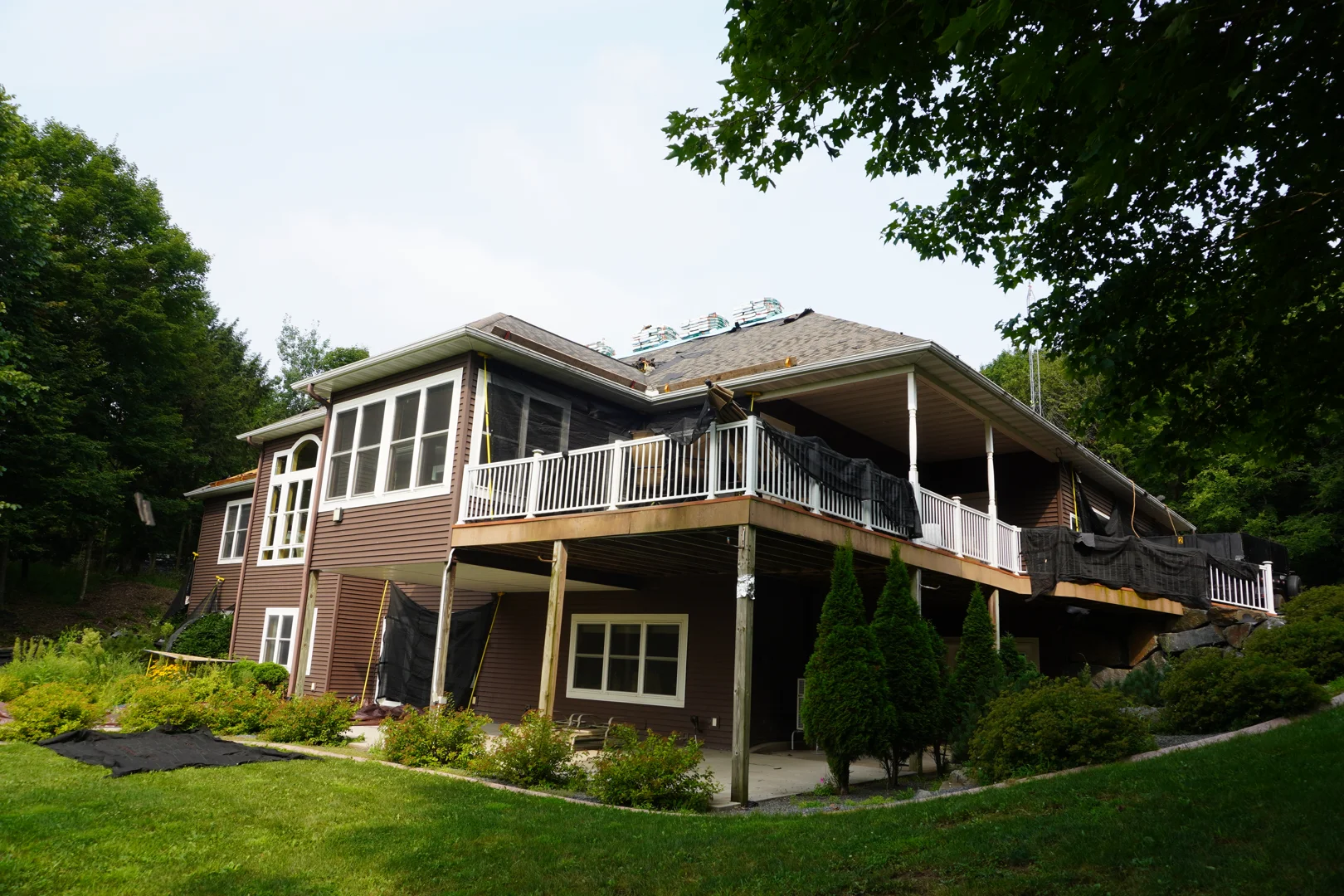 Homeowner and siding contractor reviewing exterior repair and replacement scope Homeowner and siding contractor reviewing exterior repair and replacement scope