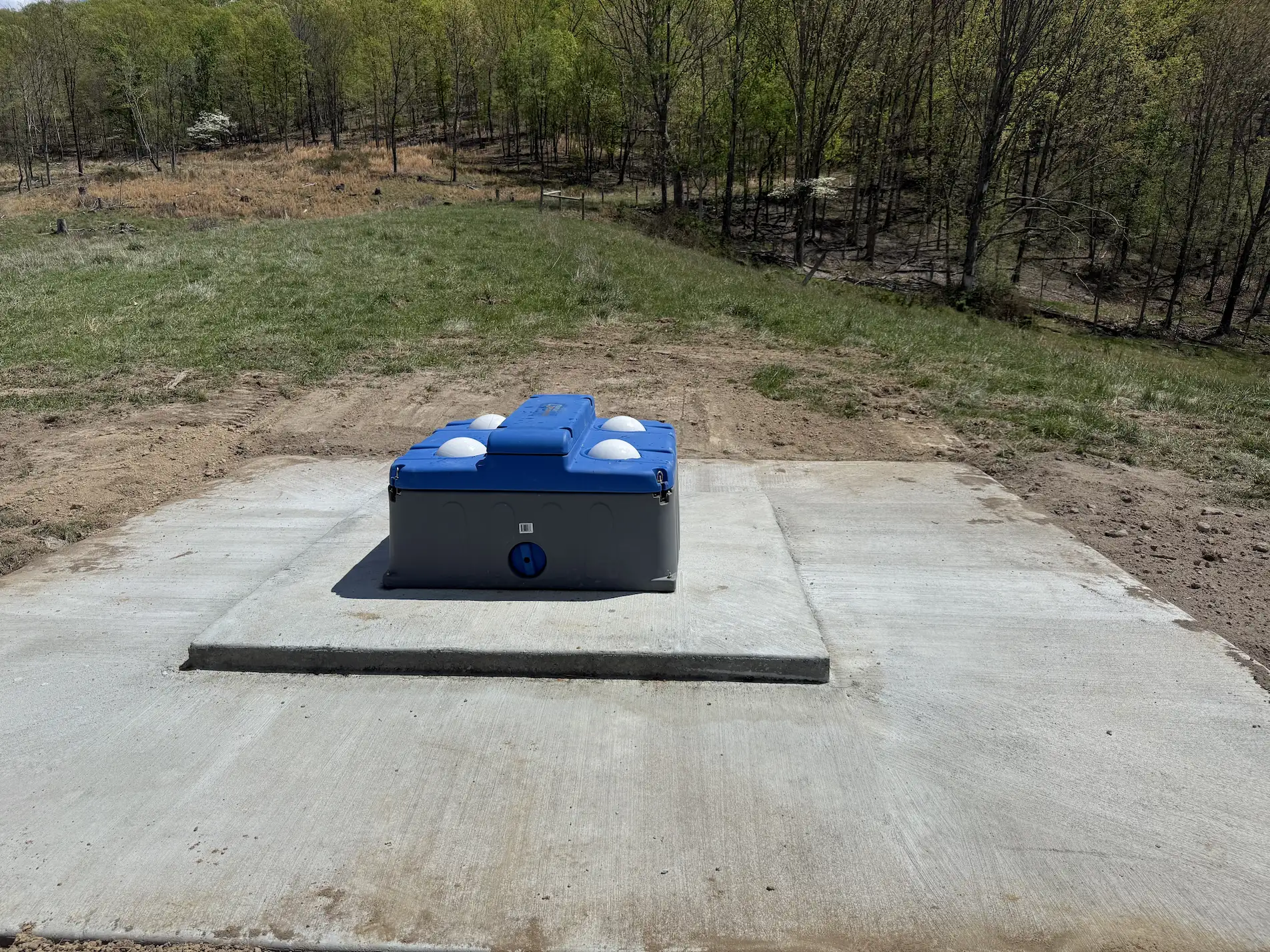 Livestock watering system built on top of concrete foundation