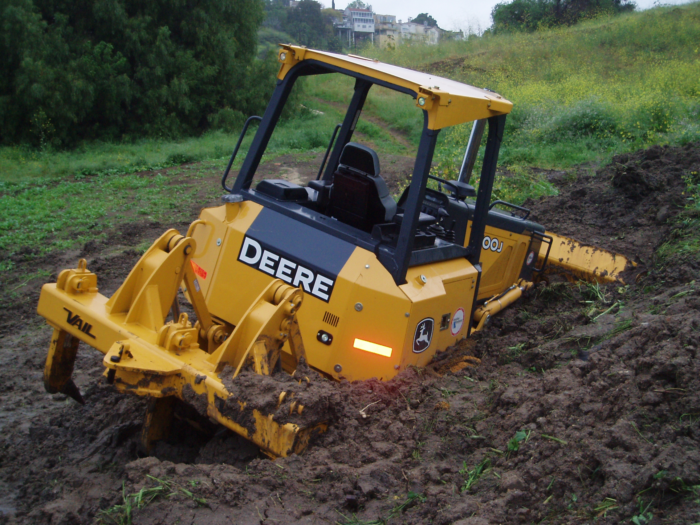 Construction equipment in sink hole after a rain