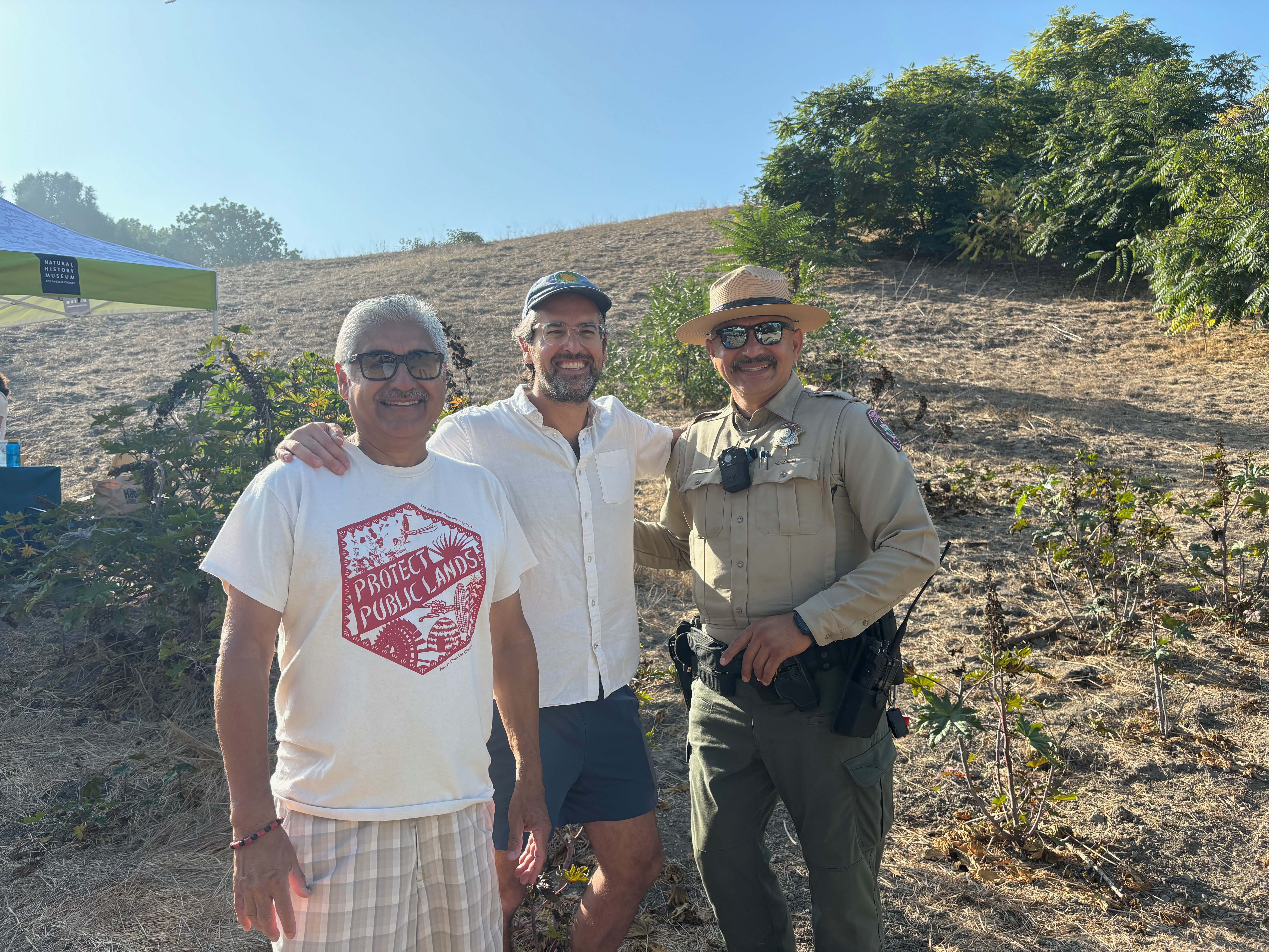two community members and a park ranger posing