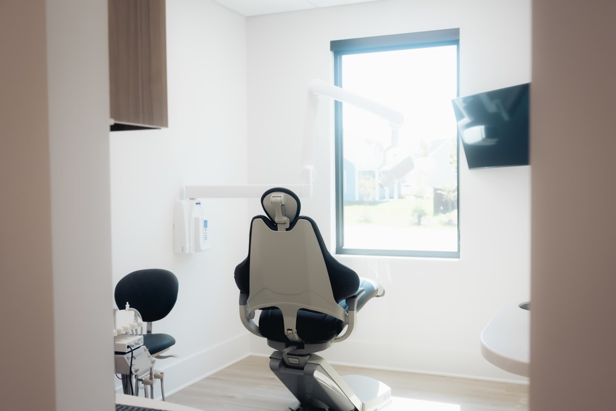 Patient in dental chair receiving orthodontic consultation in modern treatment room