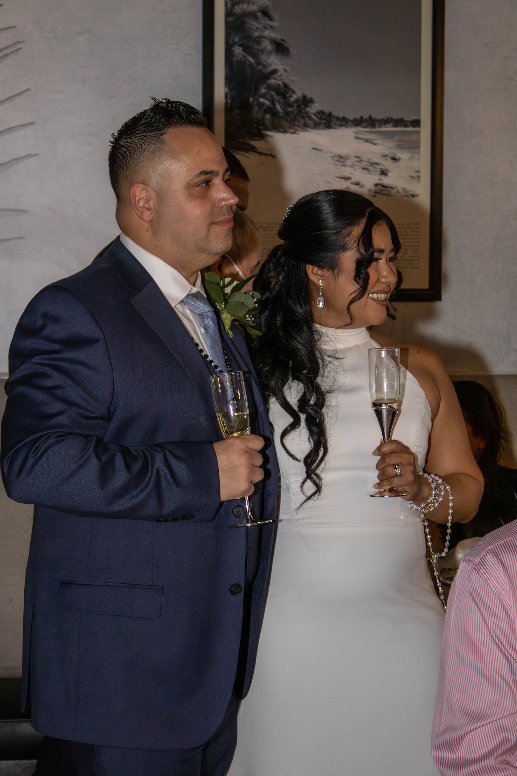 Dina and Brian on their wedding day, looking off to the side. Photographed by Nicole Collado.