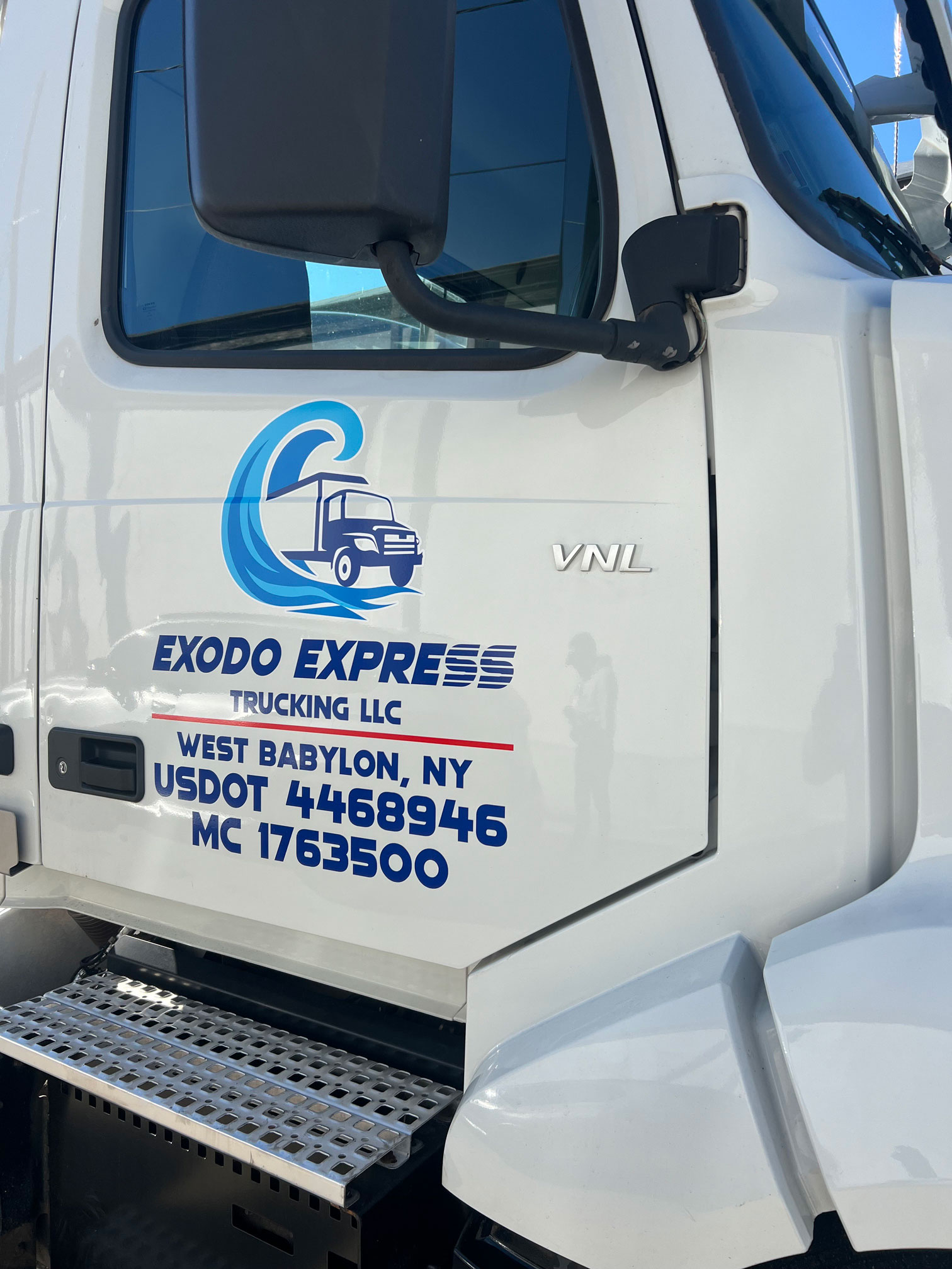 Image of an Exodo Express truck's door.
