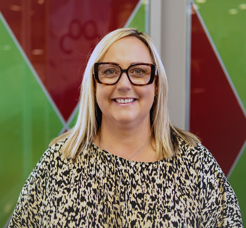 Charity customer of ImpactLab smiling to the camera