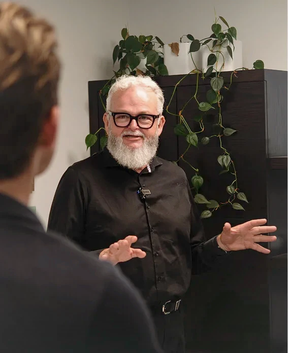 Charity customer of ImpactLab animatedly discussion his work